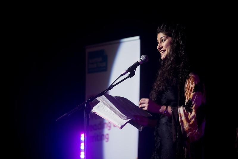 Woman speaking on stage at New Writers Awards Showcase